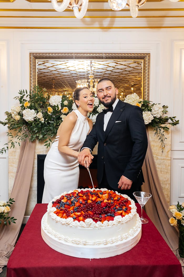 about-img Bride and groom cutting wedding cake in a beautifully decorated reception.